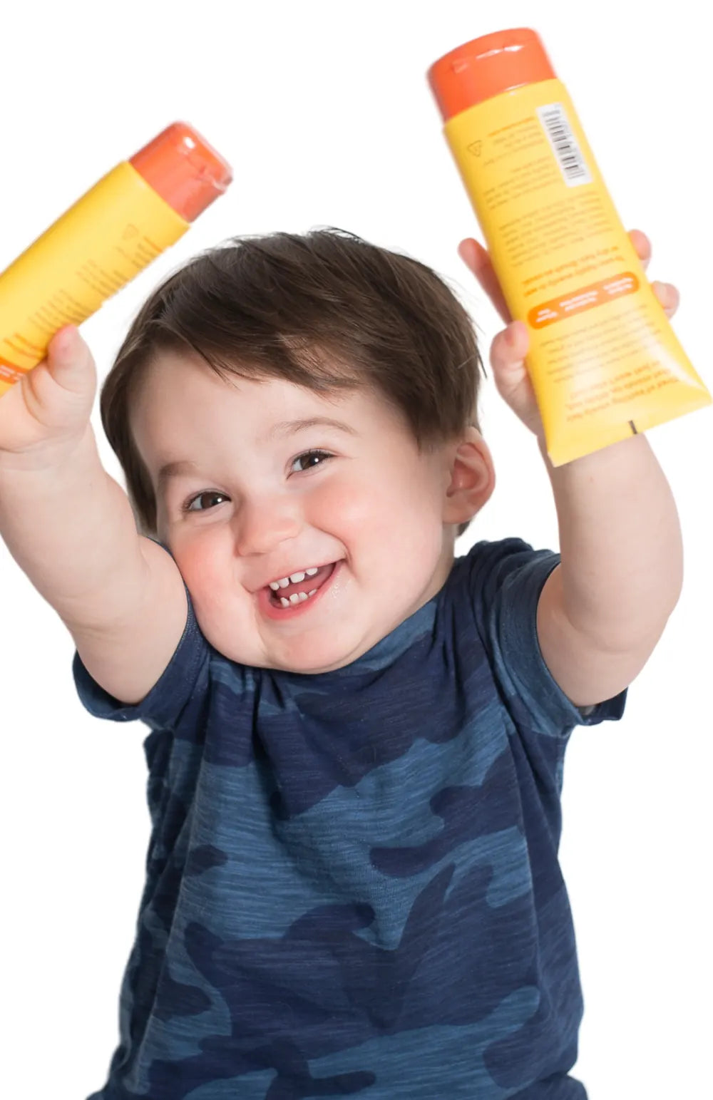 A toddler holding 2 Taming tubes over his head