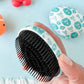 Close-up of the mini baby detangling brush